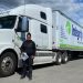 Integrity Driving School student beside a Class 1 MELT training tractor-trailer in British Columbia